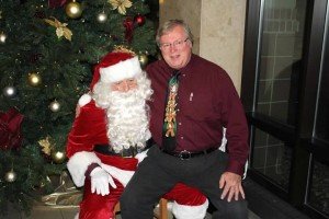 Dr. Nelson giving Santa his Christmas list.